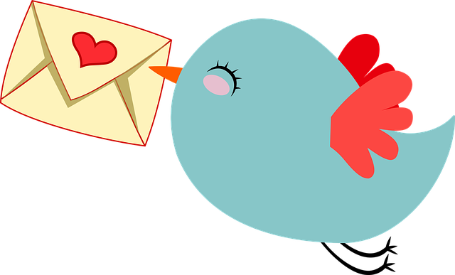 bird holding a letter with heart on it with its beck